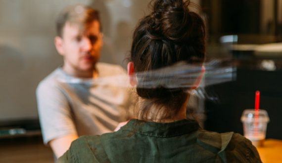 person sitting in a chair in front of a man